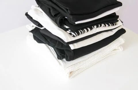 Stack of folded colorful clothes. Compact storage organizing 스톡 사진