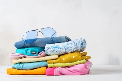Stack of folded colorful clothes. Modern casual clothing. Stock Photos