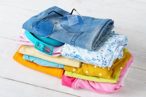 Stack of folded colorful clothes. Modern casual clothing. Stock Photos
