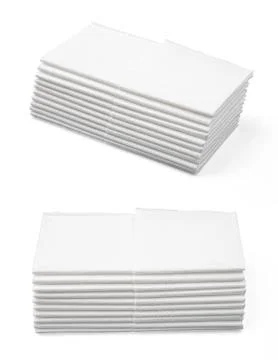 Stack of folded disposable paper tissues on white background Stock Photos