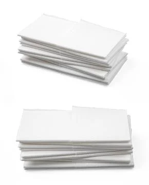Stack of folded disposable paper tissues on white background Stock Photos