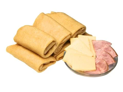 Stack of folded fried delicious golden brown pancakes with filling Stock Photos