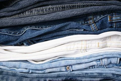 Stack of folded jeans, denim background. ?lose-up Stack of folded jeans, deni Stock Photos