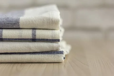 A stack of folded kitchen towels lies on the surface. Stock Photos
