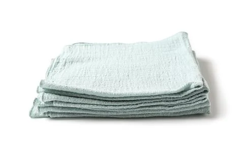Stack of folded light blue cotton gauze kitchen towels for cleaning and dryin Stock Photos