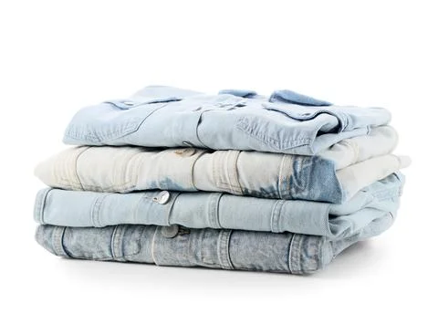 Stack of folded light blue denim shirts and jackets, casual fashion and appar Foto stock