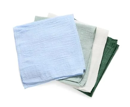 Stack of folded muslin cloths in blue, green, and white for kitchen and home  Stock Photos
