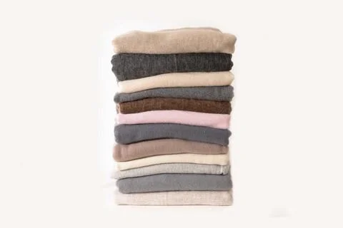 Stack folded pile of knitted cashmere with on white background Stock Photos