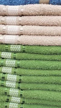 Stack of folded pink and green towels Stock Photos