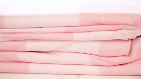 Stack of Folded Pink Gingham Bedding Sheets Stock Footage 314296233