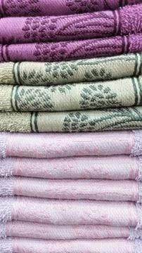 Stack of folded pink green and lilac towels Stock Photos