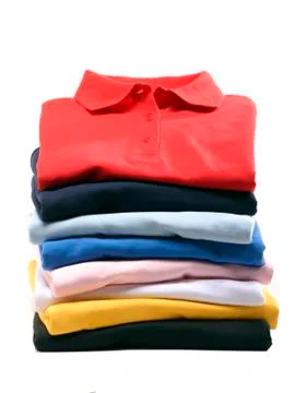 Stack of folded polo shirts isolated on white Stock Photos