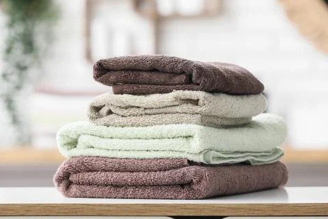 Stack of folded soft towels on table Stock Photos