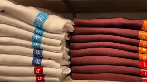 Stack of folded sweaters on display, showcasing various sizes through color.. Stock Footage 330548275
