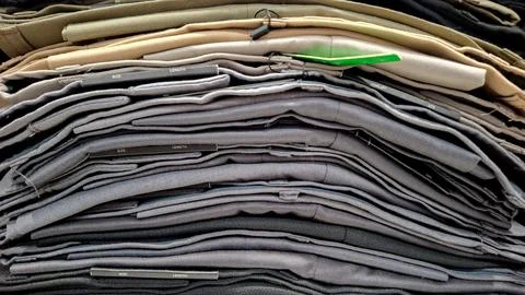 Stack of Folded Trousers and Chino Pants Close Up Stockfoto's