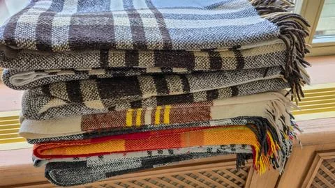 Stack of Folded Wool Blankets with Plaid and Checkered Patterns - Cozy Textile T 스톡 사진