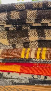 Stack of Folded Wool Blankets with Plaid and Checkered Patterns - Cozy Textile T 스톡 사진