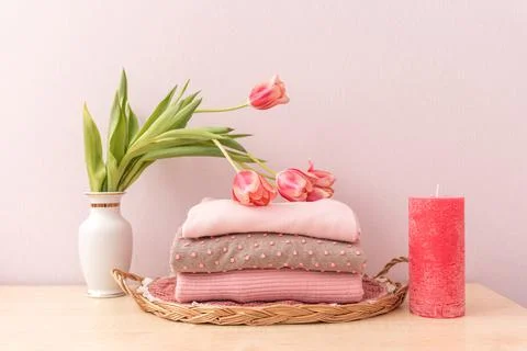 Stack of folded wool knitted sweaters or pullovers in pink pastel colors and  Stock Photos