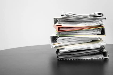 Stack of folders and documents on office table Stock Photos