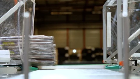 Stack Of Folders On A Machine Treadmill Passing By Stock Footage 129398931