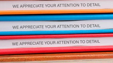 A stack of folders in vibrant colors displays a repeated message emphasizin.. Stock-Fotos
