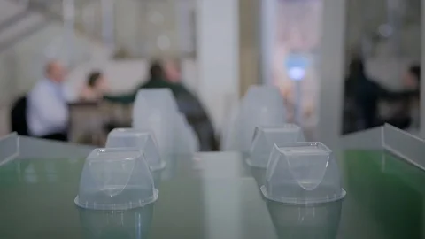 Stack of food containers on conveyor belt of plastic injection molding machine Stock Footage 117511261