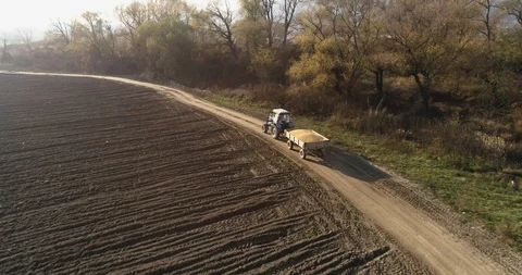 Stack of footage: Aerial view of tractor carries the harvest. 4k Stockbeeldmateriaal 116492003