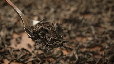 Stack of footage: Black tea fall through a spoon. Black tea. Dried tea leaves Stock Footage 121044999