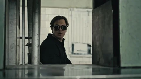 Stack of footage: Man on a steampunk glasses and looks around. Camera moves Stockbeeldmateriaal 149827236