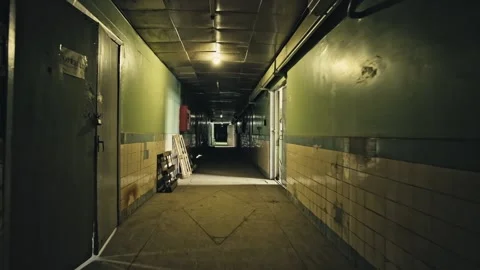 Stack of footage: Walking through Old apartment building, long dark hallway. Stock Footage 149827724