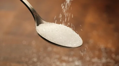 Stack of footage: White sugar fall through teaspoon down on a brown wood 스톡 동영상 121043753