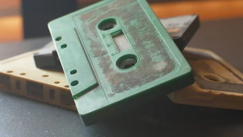 A stack of four audio cassettes on a table. Parallax movement shot 動画素材 134381724