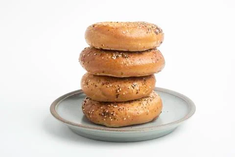Stack Of Four Bagels On Ceramic Breakfast Plate Stock Photos
