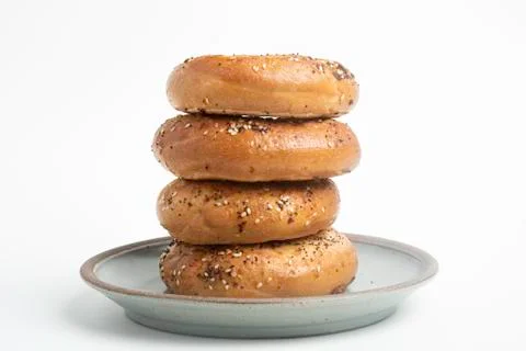 Stack Of Four Bagels On Ceramic Breakfast Plate Stock Photos