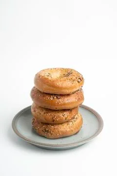 Stack Of Four Bagels On Ceramic Breakfast Plate Stock Photos
