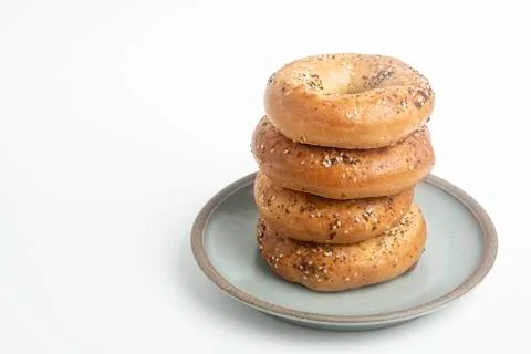 Stack Of Four Bagels On Ceramic Breakfast Plate Stock Photos