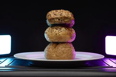 Stack of four bread buns with artistic neon light Stock Photos