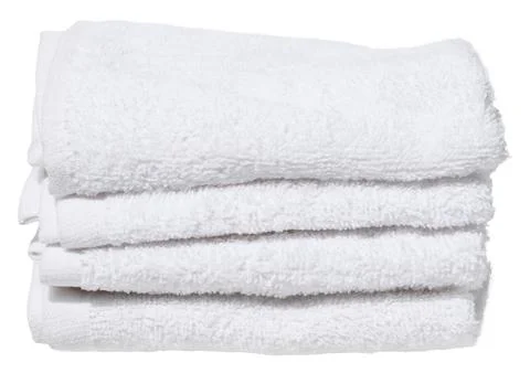 Stack of four folded white terry towels, on isolated background. Stock Photos