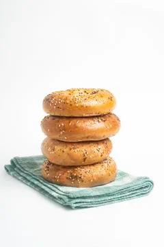 Stack Of Four Freshly Baked Bagels On Green Napkin Stock Photos
