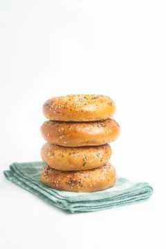 Stack Of Four Freshly Baked Bagels On Green Napkin Stock Photos