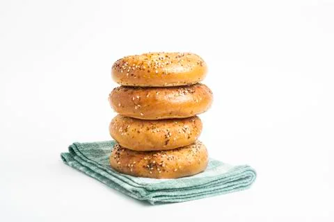 Stack Of Four Freshly Baked Bagels On Green Napkin Stock Photos