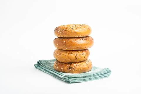 Stack Of Four Freshly Baked Bagels On Green Napkin Stock Photos
