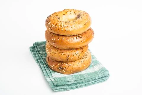 Stack Of Four Freshly Baked Bagels On Green Napkin Stock Photos