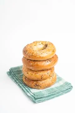 Stack Of Four Freshly Baked Bagels On Green Napkin Stock Photos