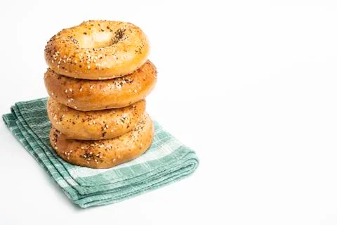 Stack Of Four Freshly Baked Bagels On Green Napkin Stock Photos