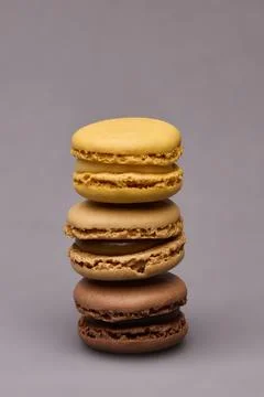 Stack of four macarons assorted colors on gray background Stock Photos