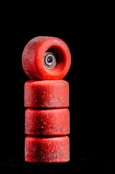 A stack of four red skateboard wheels Stock Photos