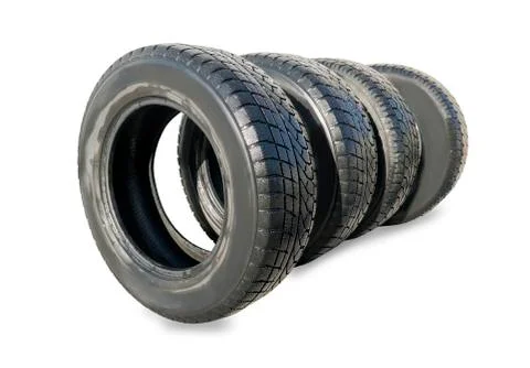 Stack of four wheel new black winter tyres for car Stock Photos