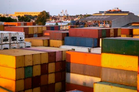 Stack of freight shipping containers at the docks. cargo port Stock Photos
