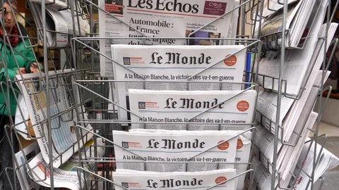 Stack of French Le monde newspaper with portrait of Stephen Hawking Stock Footage 87223807